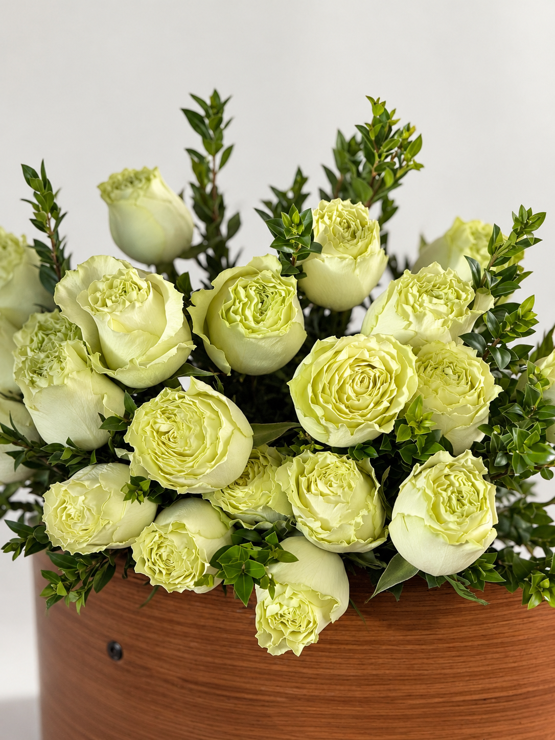 Soft green garden-style roses with layered ivory-green petals and fresh greenery, arranged as an elegant floral bouquet by Bloommood Los Angeles.